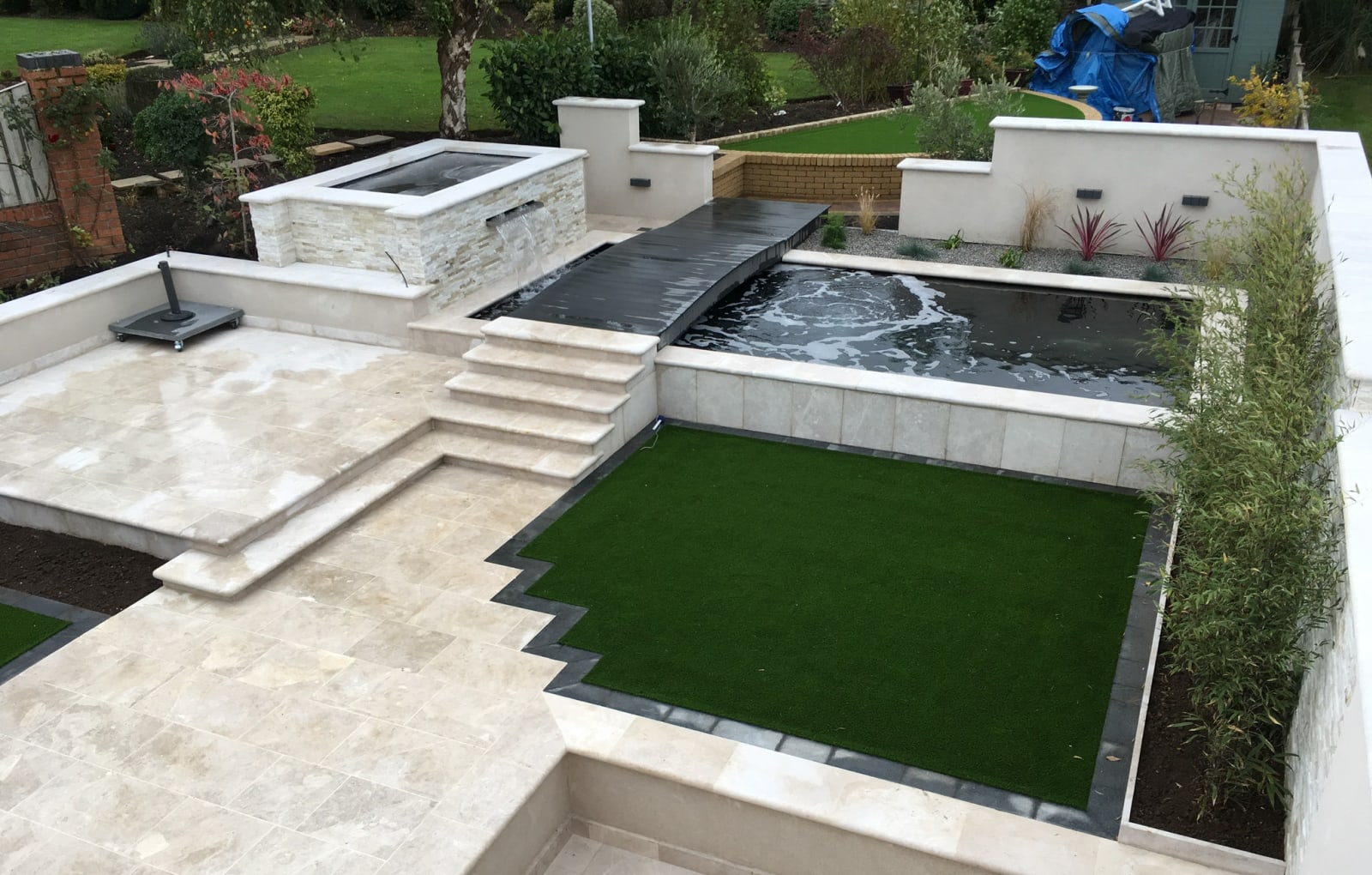 Multi-level patio with a koi pond