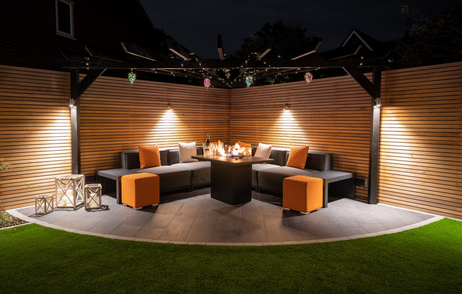 A low maintenance garden with an outdoor kitchen and seating area