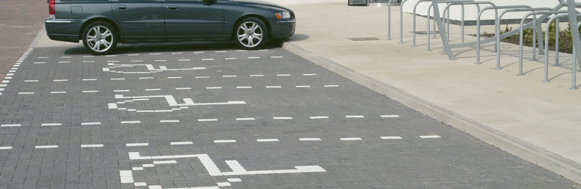 White marker blocks used to outline car spaces inside car park.