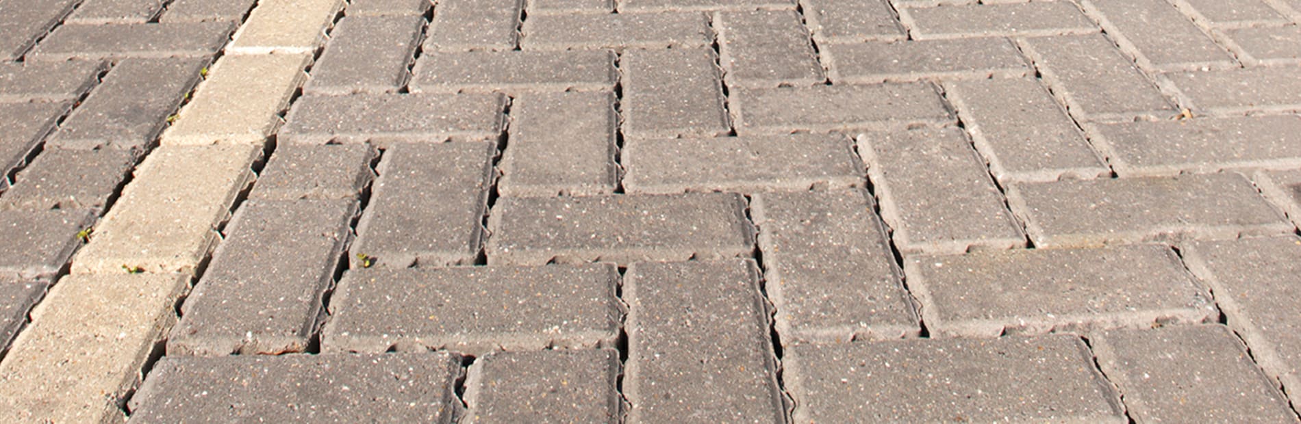 Block paving in bracken laid in a car park outside a shopping.