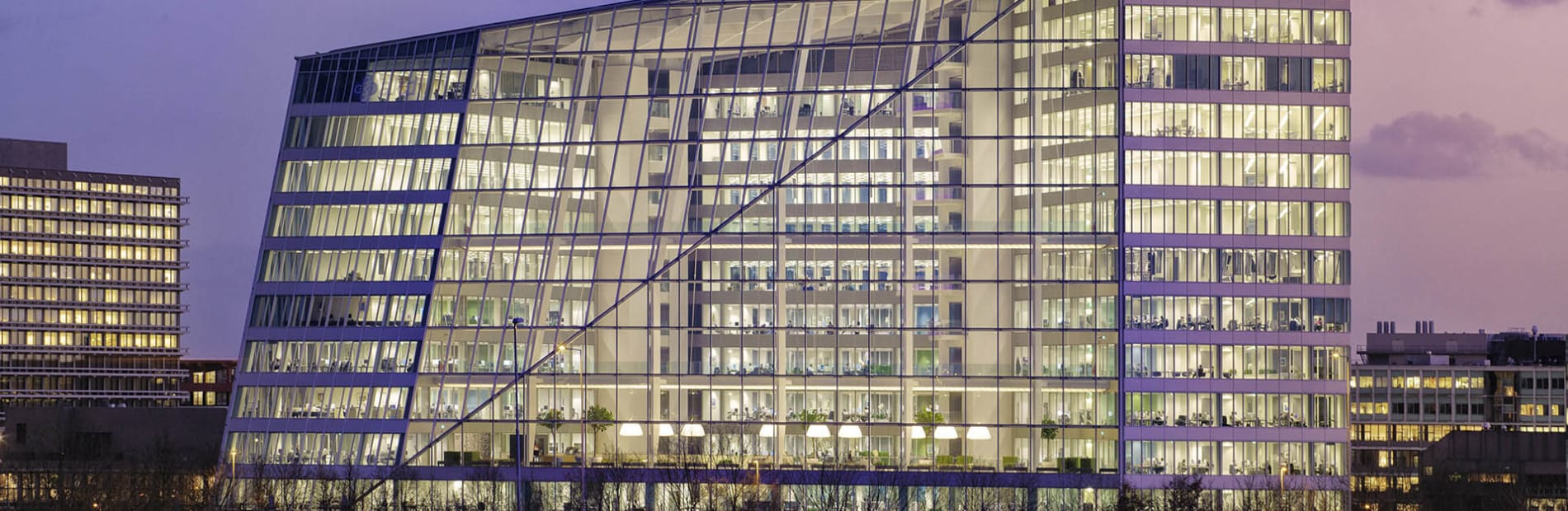 Large glass commercial building in a city