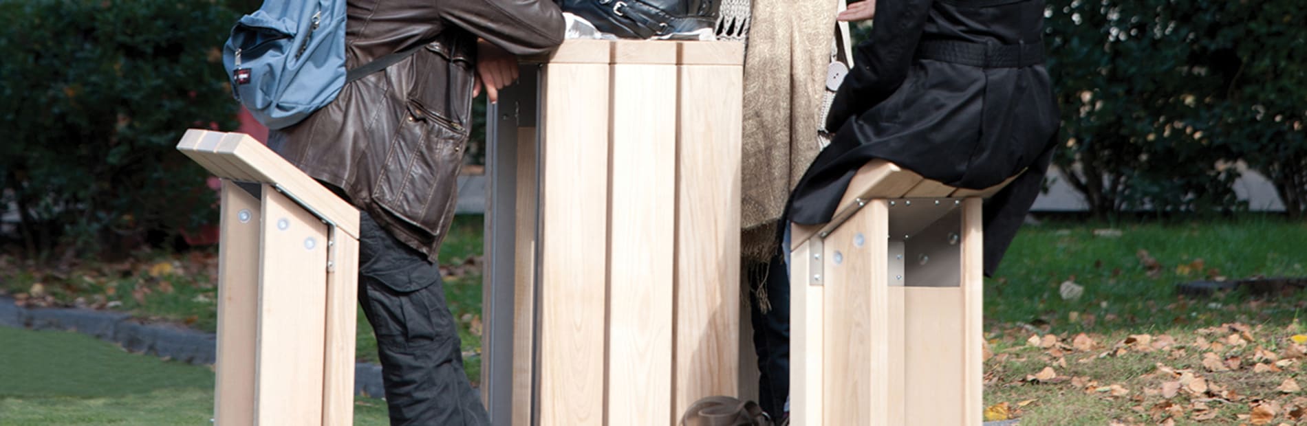 People surrounding table in the park.