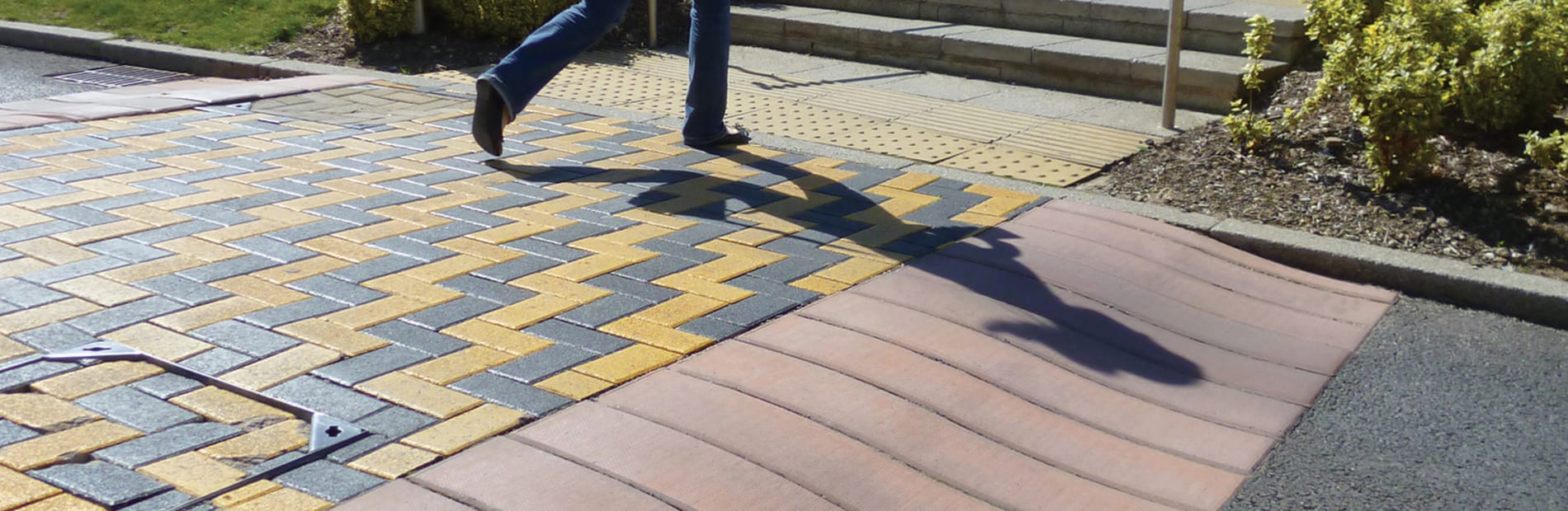 A woman walking across the S ramp reinforced concrete ramp system.