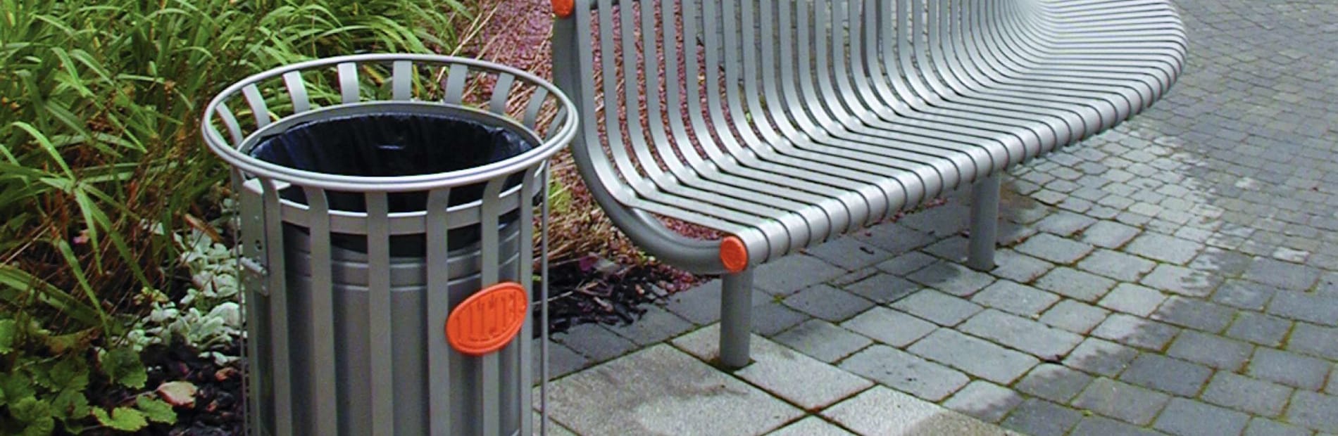 festival litter bin next to a bench