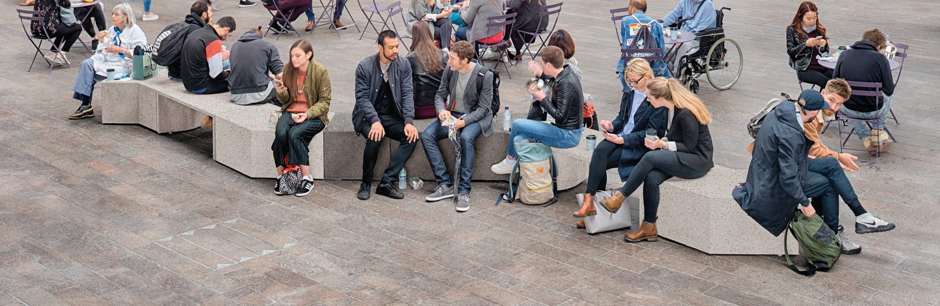 Members of the public sitting on a bench.