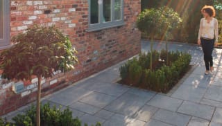 dark grey paving laid in a patio area.
