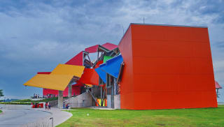 A multi-coloured building designed and built in an abstract origami shape