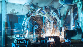 A large robot welding parts along a production line.