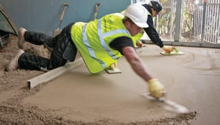 Builder laying screed