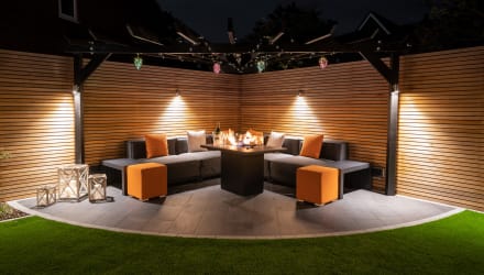 A low maintenance garden with an outdoor kitchen and seating area