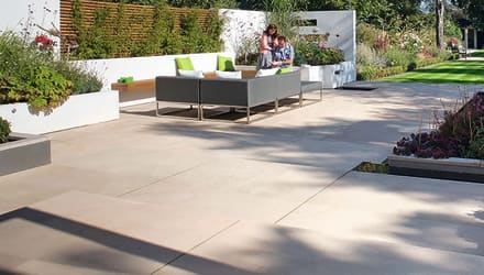 large buff paving slabs in a large garden area.