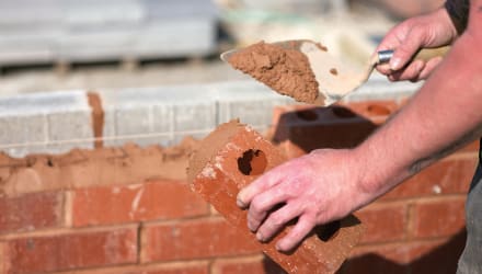 Laying bricks to build wall