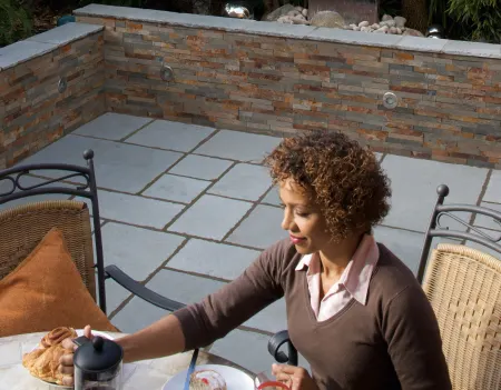 A woman eating her breakfast in her garden