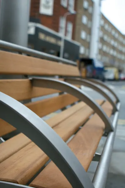 Wooden bench outside of an office building.