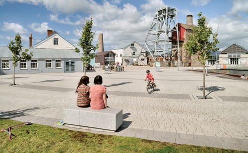 family watching children play on bicycle