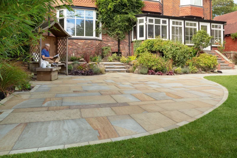 Man sat in arbour on natural stone patio