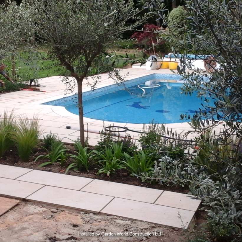 Marshalls garden paving used next to an outdoor swimming pool.