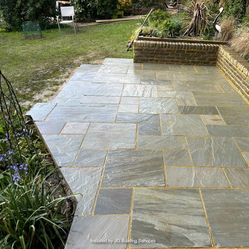 Marshalls Indian Sandstone in Grey Multi with Traditional Natural Stone Pitched Face Walling in Silver Birch installed by a Marshalls register member.