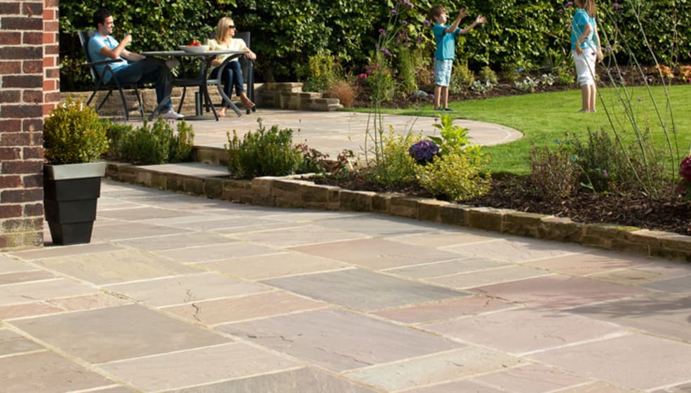 brown and buff paving coloured paving laid in a garden area.