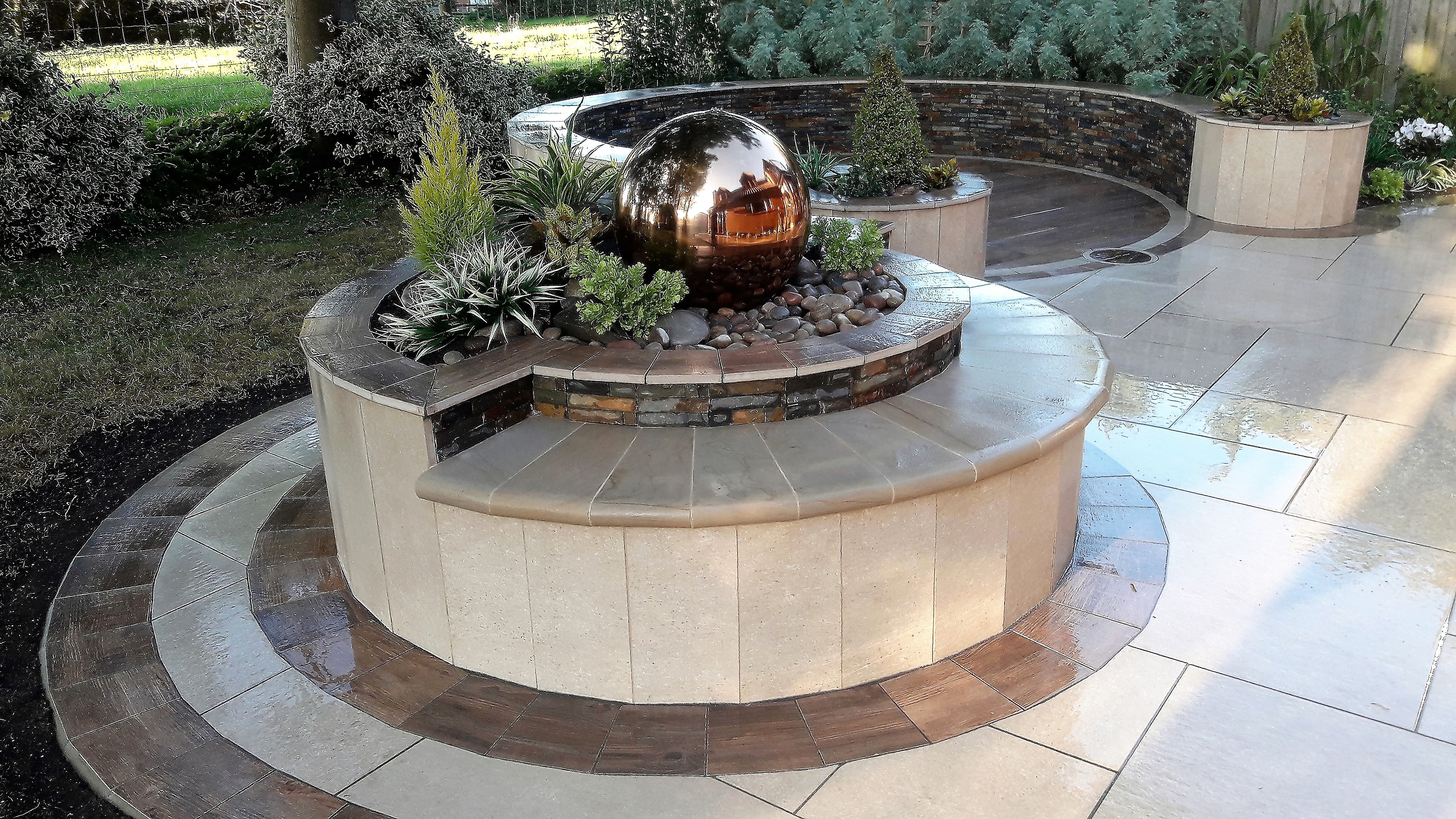 A smaller patio design, featuring bespoke circles and water feature | Marshalls A Smaller Patio Design, Featuring Bespoke Circles And Water Feature | Marshalls