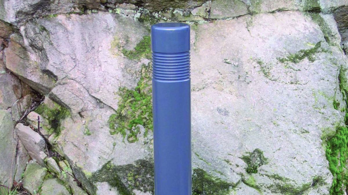blue bollard near a rock