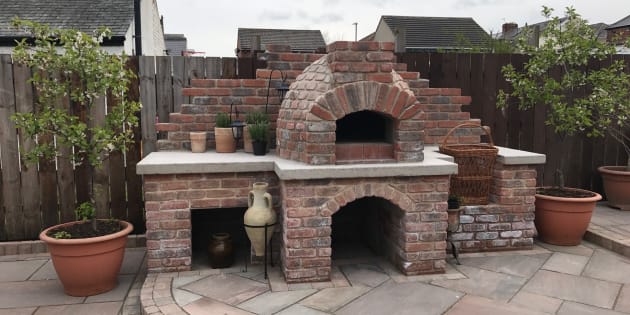 Brick built pizza oven with indian sandstone patio