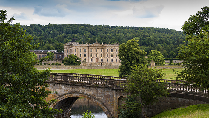 Chatsworth house next to a bridge