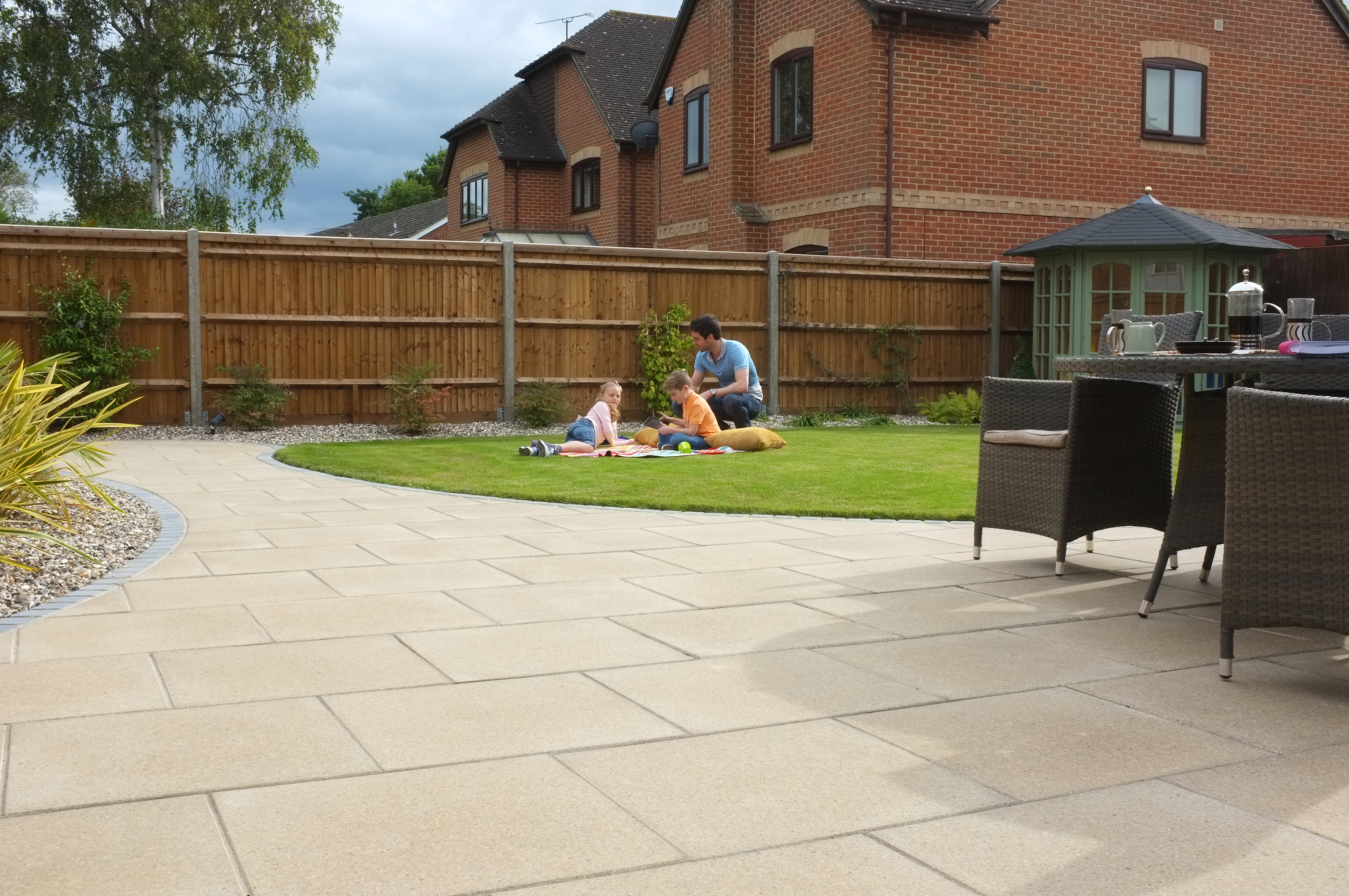 A perfectly-laid lawn with a family playing on it