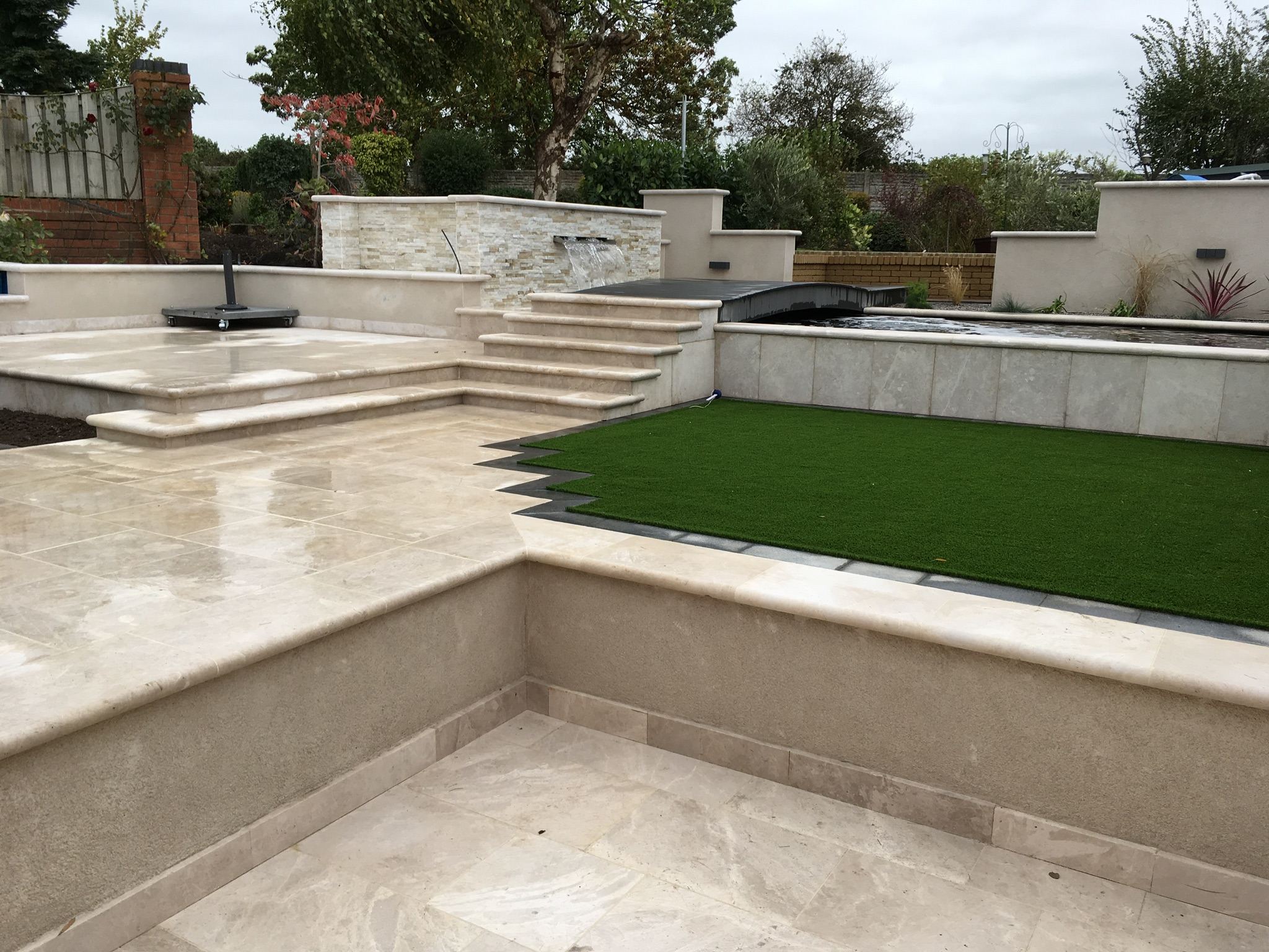 Multi Level Patio Featuring A Koi Pond And Secret Garden Escape