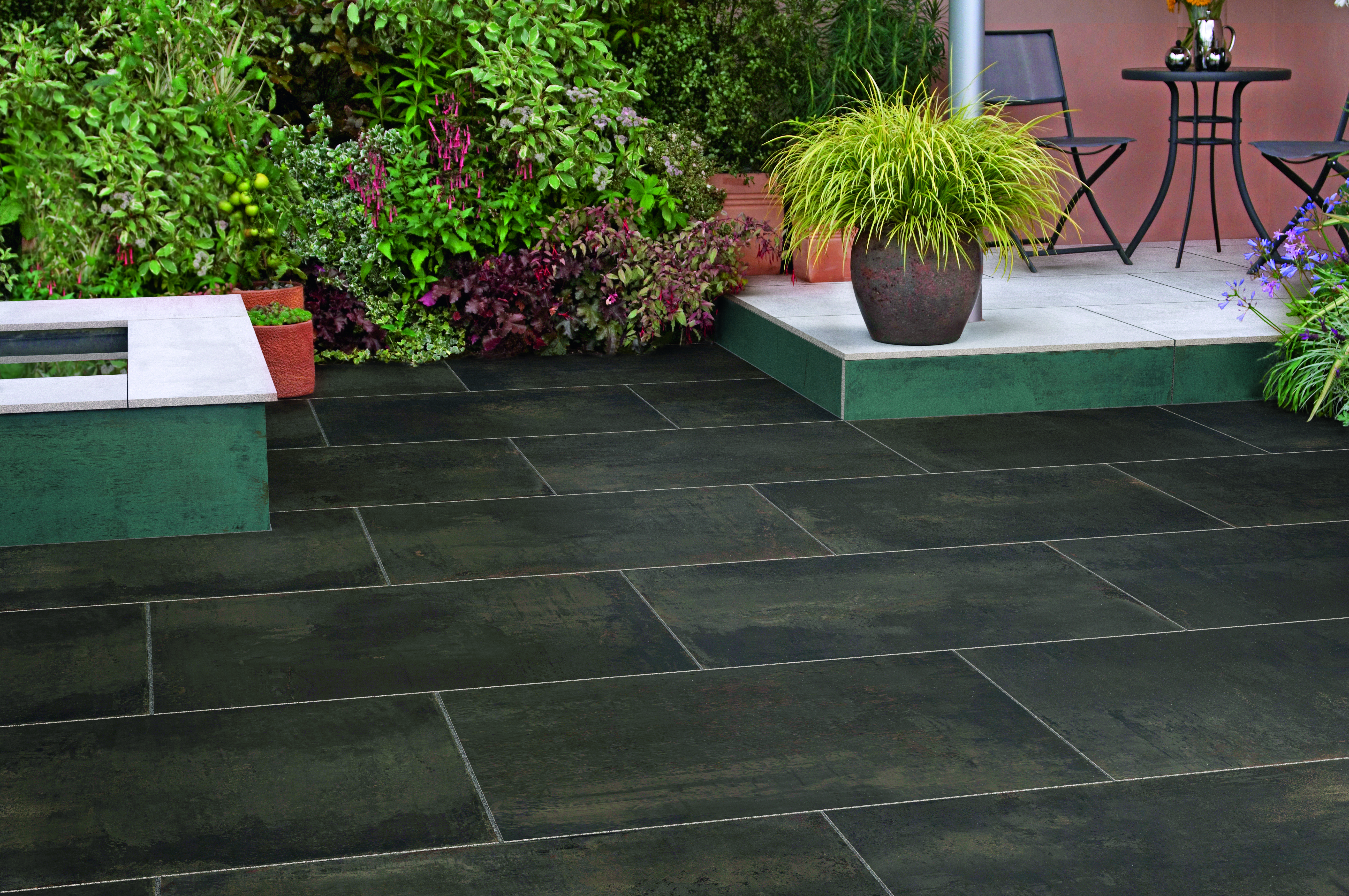 Brown garden paving with a raised level in the background