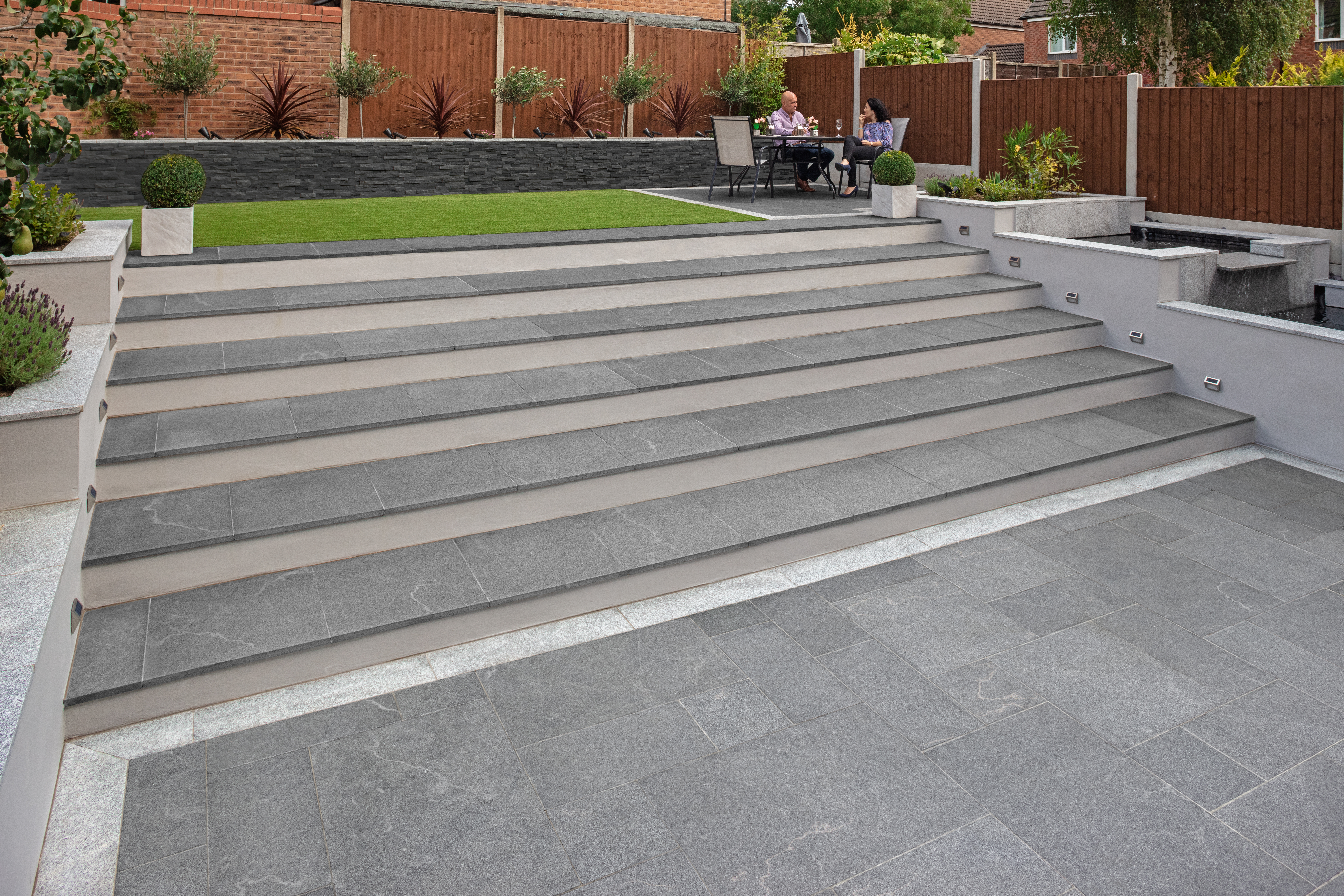 Grey garden steps leading up to a patio