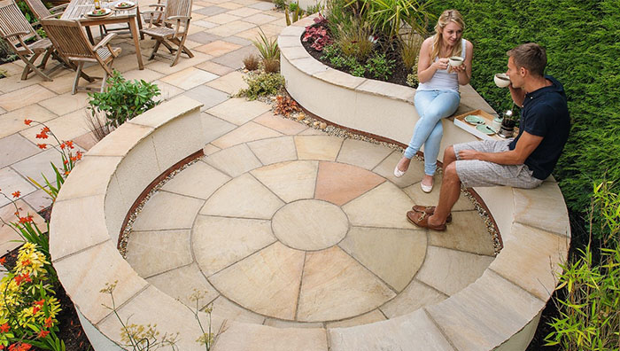 A man and woman sit in an Indian Sandstone Circle