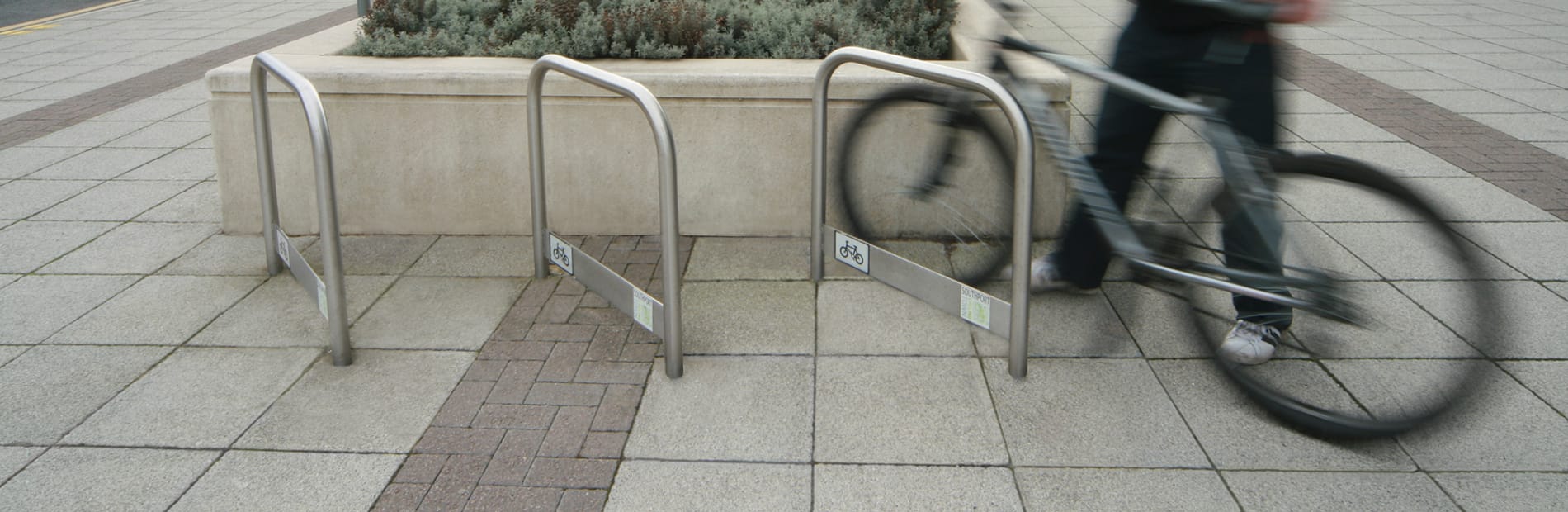 cycle rack stainless steel with a man attaching his bike